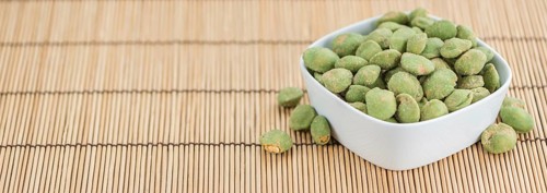 Wasabi Peanuts on a vintage background as detailed close-up shot (selective focus)