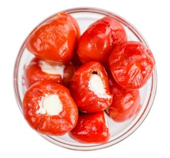 Fresh made Red Pepper (stuffed with cheese) isolated on white background (close-up shot)