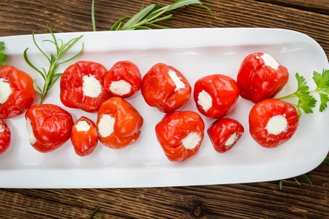 Homemade Filled Pimientos on vintage background (selective focus, close-up shot)