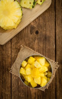 Fresh made Pineapple (sliced) on a vintage background as detailed close-up shot