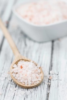 Pink Salt on a vintage background as detailed close-up shot (selective focus)