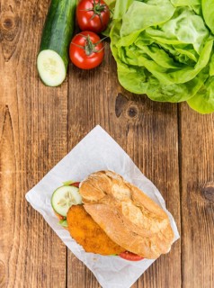 Chicken Schnitzel on a bun (selective focus, detailed close-up shot)