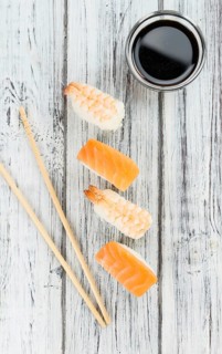 Portion of Sushi on a wooden table (selective focus, close-up shot)