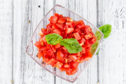 Homemade Cutted Tomatoes on vintage background (selective focus, close-up shot)