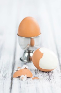 Some boiled Eggs (close-up shot, selective focus) on an old wooden table