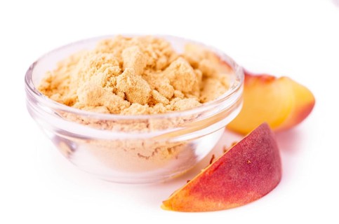 Portion of Ground Peaches as detailed close-up shot isolated on white background