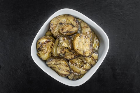 Homemade Antipasti (Grilled Zucchinis) on vintage background (selective focus, close-up shot)