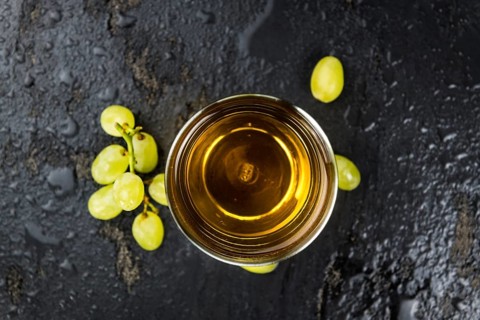 Portion of healthy Grape Juice on a slate slab (selective focus)