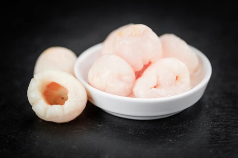 Fresh made Lychees (preserved) on a vintage background (close-up shot)