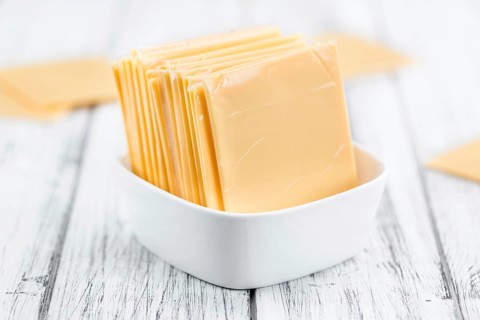Portion of sliced Cheese (close-up shot, selective focus)