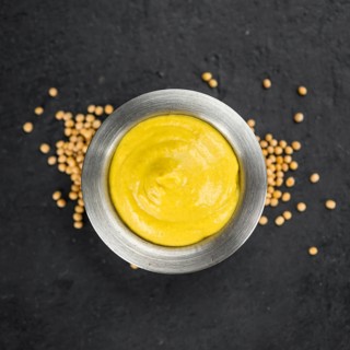 Mustard on a vintage slate slab (close-up shot, selective focus)