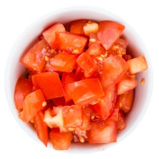 Portion of Diced Tomatoes (as close-up shot) isolated on white background