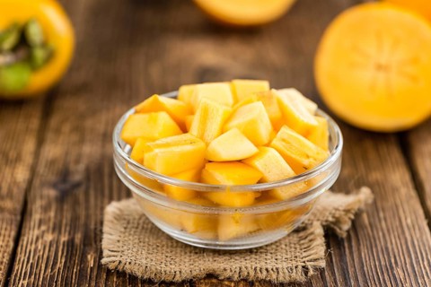 Portion of fresh made Kaki fruits (close-up shot, selective focus)