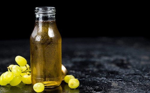 Some healthy Grape Juice on a vintage slate slab (selective focus)