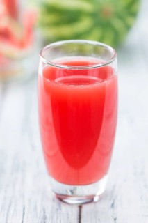 Homemade Watermelon Smoothie on an wooden table (selective focus) as detailed close-up shot