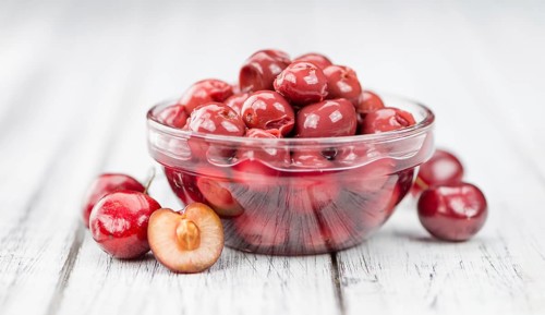 Preserved Cherries on a vintage background as detailed close-up shot, selective focus