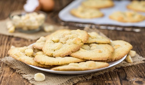 Vintage wooden table with Cookies (selective focus, close-up shot)
