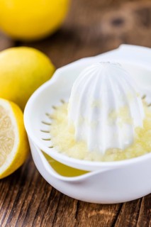 Lemon Juice on a vintage background as detailed close-up shot (selective focus)