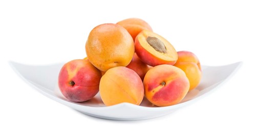 Portion of Apricots (as close-up shot) isolated on white background