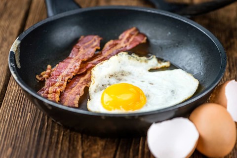 Portion of Bacon and Eggs (selective focus, close-up shot)