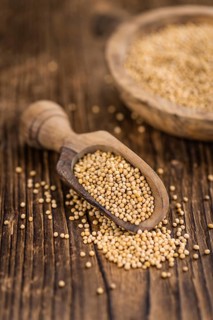 Mustard Seeds on rustic wooden background (close-up shot)