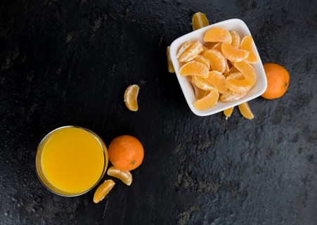 Fresh made Tangerine Juice on a vintage slate slab (selective focus)