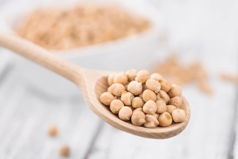 Chickpeas on an old wooden table as detailed close-up shot, selective focus