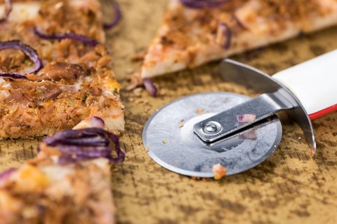 Portion of sliced Pizza (detailed close-up shot, selective focus)