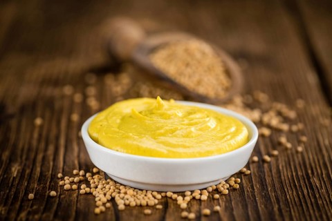 Mustard on a vintage background as detailed close-up shot (selective focus)