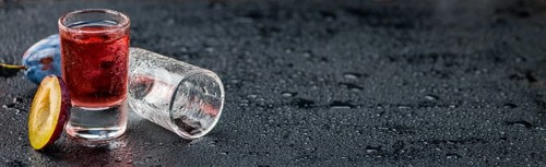 Some Plum Liqueur on a vintage slate slab, selective focus