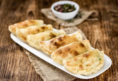 Portion of fresh homemade Empanadas as detailed close-up shot, selective focus