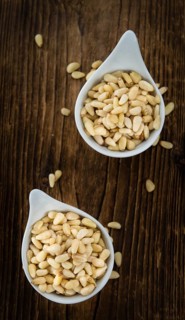 Pine Nuts on a vintage background as detailed close-up shot (selective focus)