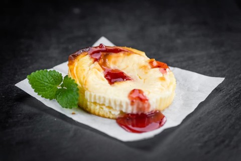 Cheesecake with Sauce on a vintage slate slab (close-up shot, selective focus)