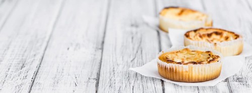 Fresh made Mini Cheesecake on a vintage background (close-up shot)