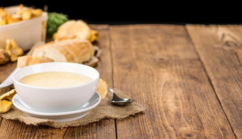 Fresh made Chanterelle Soup on a vintage background as detailed close-up shot