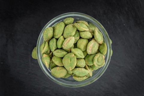 Some fresh Wasabi Peanuts on a vintage slate slab (selective focus, close-up shot)