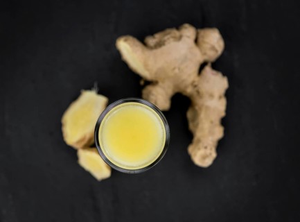 Fresh made Ginger Drink on a slate slab (close-up shot, selective focus)