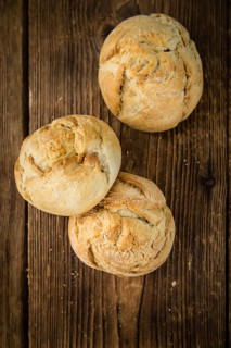Rolls (German style) on rustic wooden background as close-up shot