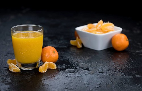 Tangerine Juice (close-up shot) on a vintage looking slate slab
