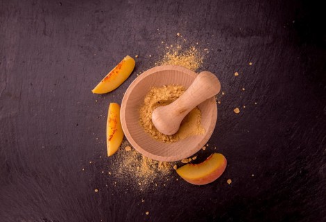 Peach powder on a vintage slate slab as detailed close-up shot, selective focus