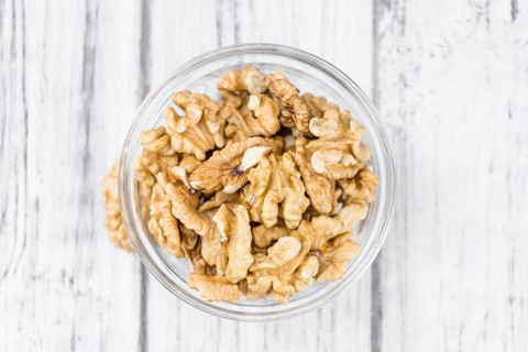 Walnut kernels on a vintage background as detailed close-up shot (selective focus)