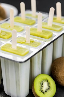 Kiwi Popsicles on a vintage looking slate slab (selective focus)