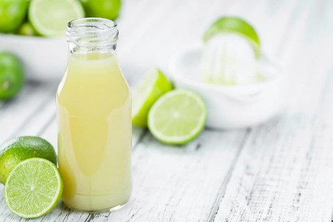 Portion of fresh Lime Juice (close-up shot, selective focus)