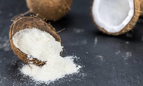 Some fresh made Coconut flour on a vintage slate slab (selective focus)