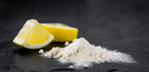 Some healthy Lemon powder on a vintage slate slab (selective focus)
