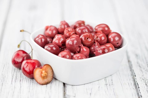 Preserved Cherries on a vintage background as detailed close-up shot, selective focus