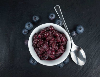 Some fresh Preserved Blueberries on a vintage slate slab, selective focus, close-up shot