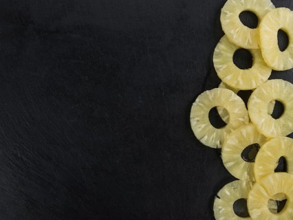 Some fresh Preserved Pineapple Rings on a vintage slate slab, selective focus, close-up shot