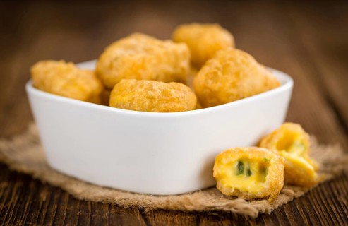 Chili Cheese Nuggets on a vintage background as detailed close-up shot (selective focus)