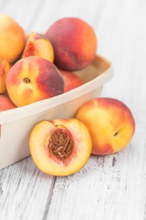 Portion of fresh Peaches close-up shot, selective focus